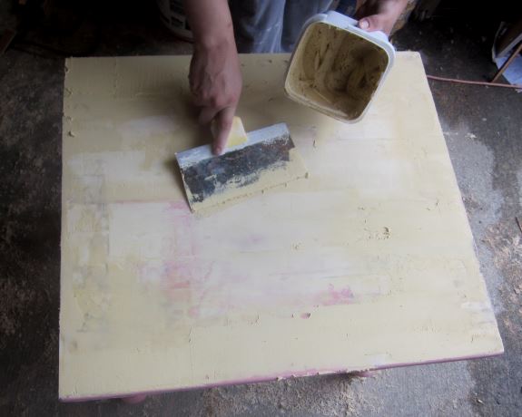 3. Fill in any uneven spots on the table top with wood filler