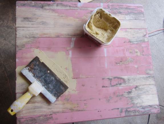 3. Fill in any uneven spots on the table top with wood filler