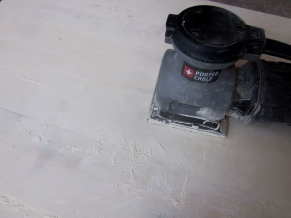 After table top is dry, sand evenly